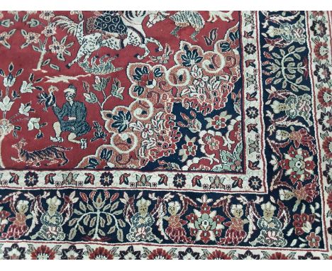 TURKISH SCHIRAZ RUG with traditional hunting design, on a red ground300cm x 200cm