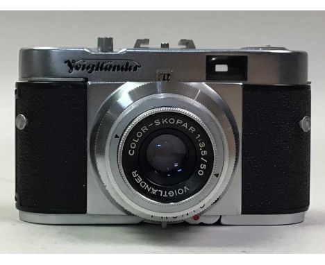 CASED GERMAN CAMERA BY VOIGTLANDER AND OTHER ITEMS comprising a vintage tape measure, extentable rules, a cased telescope, pa