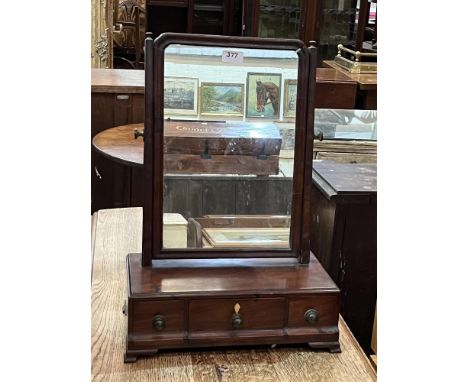A George III mahogany dressing mirror with three cavetto base drawers on bracket feet. 15" wide.