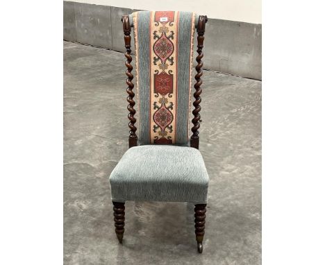 A Victorian rosewood prie-dieu chair with barleytwist turned back, on bobbin turned forelegs.