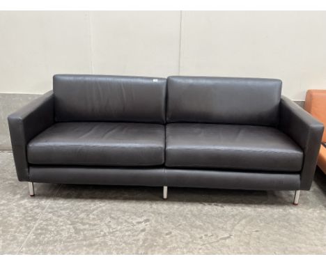 A contemporary style sofa upholstered in black leather. 88" wide.