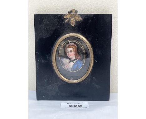 A 19th century portrait miniature of a young lady with a fan. Painted in enamels on a porcelain oval plaque. The ebonised fra