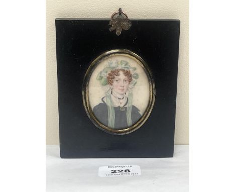 A 19th century portrait miniature of a lady wearing a bonnet. The ebonised frame 5¼" high.