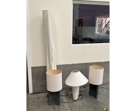 A floor lamp; a pair of stone based table lamps and a ceramic based table lamp. (4)