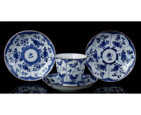 Porcelain cup and 3 saucers with blue floral decor divided into cartouches, China Kangxi period ca. 1720, cup 8 cm high (cup 