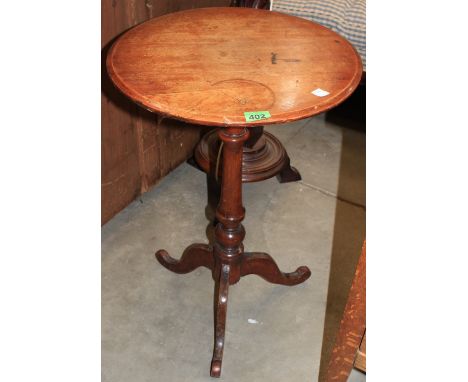 	A walnut tripod table, 18 diam. A walnut tripod table