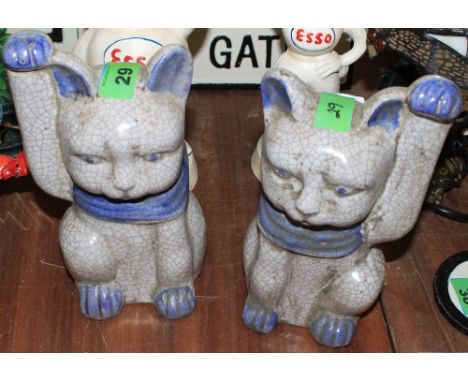 	A pair of Oriental style ceramic cat figures