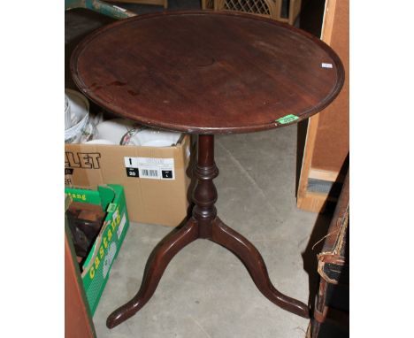 	A George III mahogany tripod table, the dished snap-top with birdcage and columnar support. 23' diam.