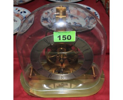 	A continental gilt brass skeleton mantle clock, the movement with dead beat escapement and stamped KJB, on onyx base and und