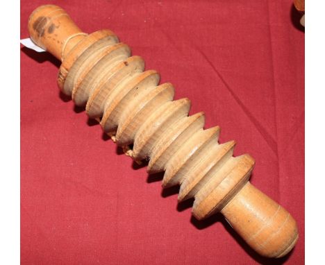 	A 19th Century elm oatmeal roller with serrated body. 8 ½' long 