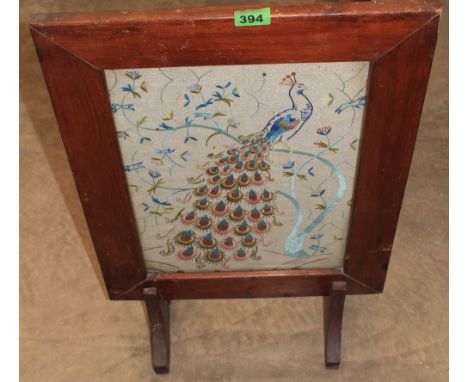 	A firescreen with embroidered panel of a peafowl