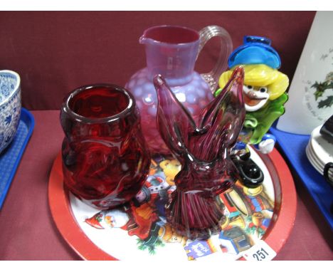 A XIX Century Cranberry Dimpled Water Jug, ruby nobbled vase, amethyst spill vase, glass clown. 