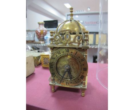 A Smiths Brass Eight Day XVII Century Style Lantern Clock, bell with finial over a circular dial, Roman numerals, turned feet