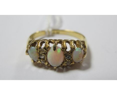 A Three Stone Opal Ring, graduated claw set, with inset spacer highlights (lacking one), indistinctly stamped "18ct". 