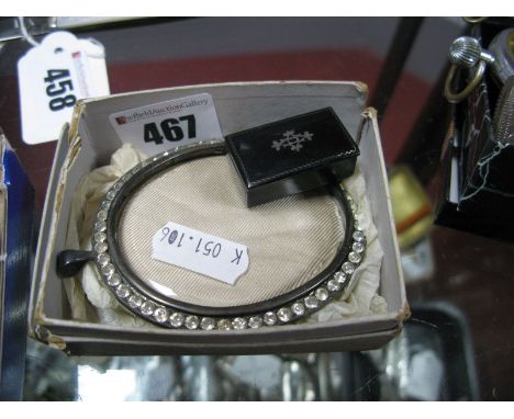 A XIX Century Black Lacquer Snuff Box, with inset detail; together with an oval glazed pendant frame, set with colourless pas