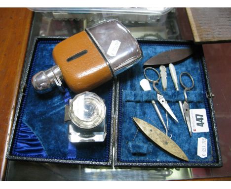 A Plated Mounted Glass Hip Flask, with removable base cup, inkwell, mother or pearl handled implements, etc.