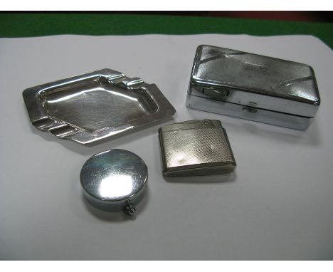 A Volkswagen Engine Turned Lighter, stamped "Made in Germany"; together with a compass, an Art Deco ashtray and en engine tur