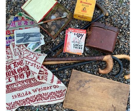 A large trunk full to include 19th cent paktong mounted chinese opium pipe, walking canes, samplers, corkscrews, toys, magazi