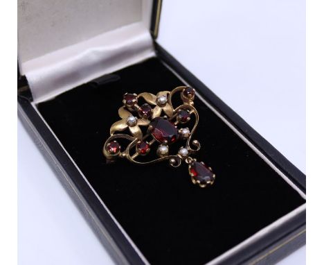 An Edwardian precious yellow metal, garnet and pearl pendant/brooch,&nbsp;yellow metal assessed as 18ct. gold), width 38mm, g
