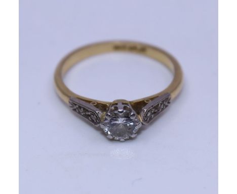 An 18ct. yellow gold, platinum and diamond ring, set central round brilliant cut diamond (estimated weight approx. 0.60 carat