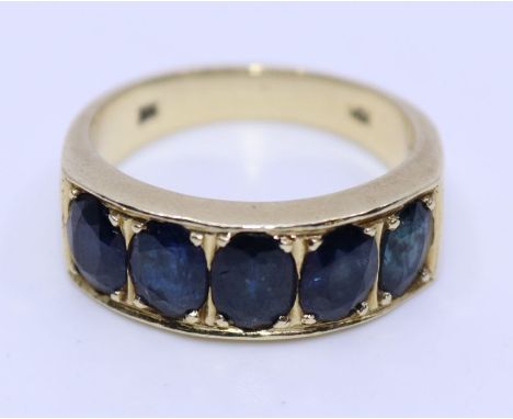 A 14ct. yellow gold five stone sapphire half-hoop ring,&nbsp;set five graduated oval mixed cut sapphires, gross weight 7.6g, 