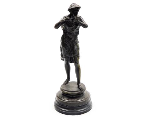 A 19thC spelter figure, of a man in classical dress playing a flute, on a hardwood base, 34cm high.