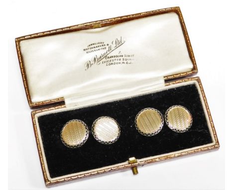 A pair of 9ct gold cufflinks, each circular with engine turned detailing and outer black enamel design, with curb links, 5.9g