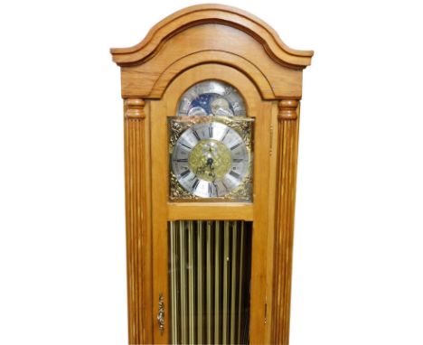 A Timecraft light oak longcase clock, with an arched moon phase dial, decorated with cherubic spandrels, silvered chapter rin