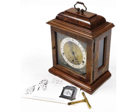 A 20thC Elliott walnut cased mantel clock, with a brass square dial, cherub spandrels, silvered dial bearing Roman numerals, 