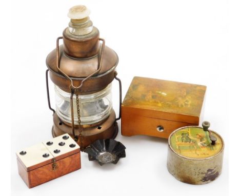An early 20th music box with a Swiss movement, the hinged lid decorated with a transfer image of children playing, playing tw