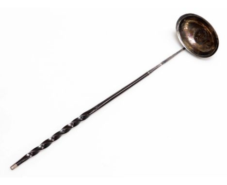 A Georgian toddy ladle, the bowl inset with a George II coin, with a whale bone twisted stem handle, 36.5cm long. 