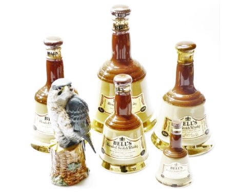 A collection of Bells Old Scotch Whisky decanters, of various sizes, the largest 24cm high, and a Royal Doulton Whyte and Mac