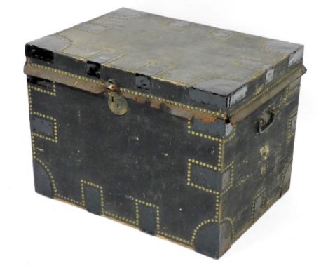 An early 20thC black leather and metal bound travelling trunk, brass studded, the hinged lid enclosing a vacant interior, 57c