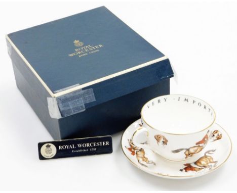 A Royal Worcester hunting scene cup and saucer, depicting various huntsmen on horseback with hounds, boxed.We have specific i