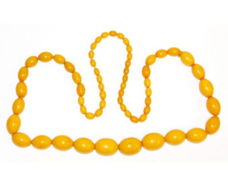 An imitation butterscotch amber beaded necklace, with light amber beads, of graduated form, on string strand, the largest 2.5
