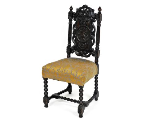 A 17thC style carved oak dining chair, the foliate carved crest rail above a splat carved with dragon rampant, with an overst