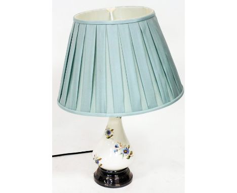 A pottery table lamp, with turquoise material shade on a metal base, 68cm high.