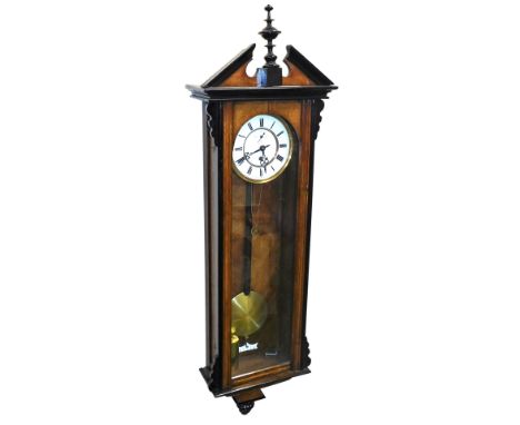 A late 19thC mahogany and ebonised cased Vienna wall clock, the circular dial with enamel chapter ring bearing Roman numerals