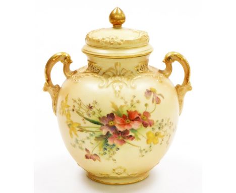 A Royal Worcester blush ivory porcelain two handled vase and cover, decorated with flowers and gilt highlights, stamped to un