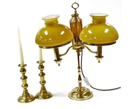 A collection of brassware, comprising a pair of Victorian candlesticks, 20cm high, and a two branch table lamp, with coloured