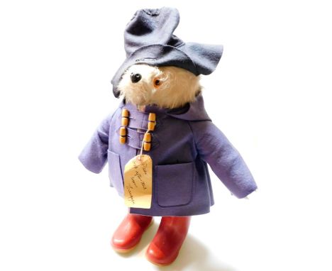 A mid 20thC Paddington Bear jointed teddy bear, in blue duffel coat with blue felt hat and red Dunlop Wellington boots, 48cm 