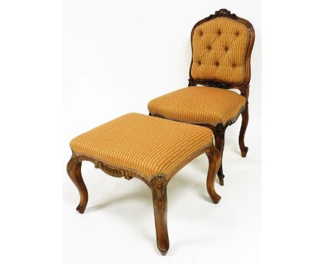 A French walnut open chair, with button back and overstuffed seat, in floral material, with shaped framed centred by a shell 
