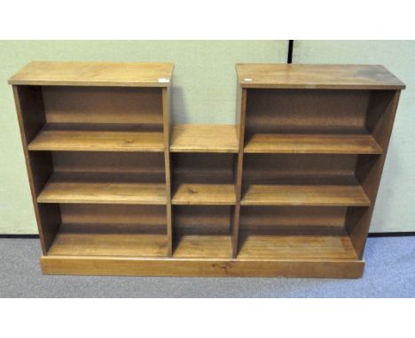 A retro style wooden book shelf, each side with two shelves linked with a central single set of shelves, 149 cm x 95 cm x 26 