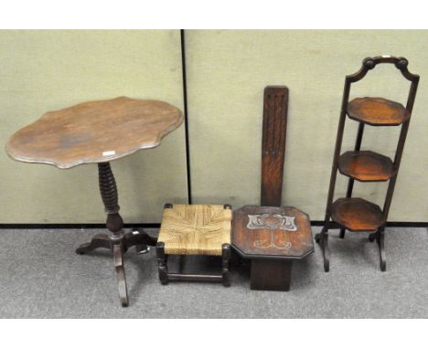 A group comprising an oak footstool with wicker seat, 23 cm x 30 cm x 30 cm, an Arts and Crafts style oak spinning chair, hei