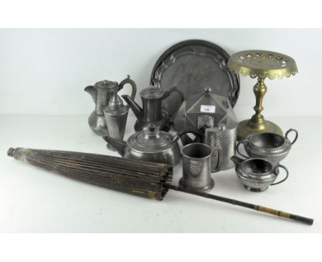 A collection of Arts and Crafts style hammered pewter, including a teapot, coffee pots, milk jug, sugar bowl, hip flask, a bo