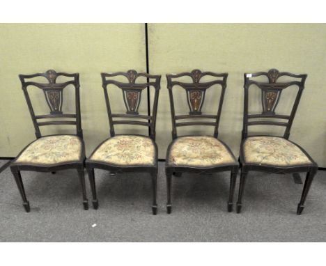 A set of four Edwardian mahogany, marquetry inlaid dining chairs with tapestry upholstery, total height 87 cm