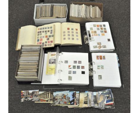A large assortment of postcards, First day covers and a collection assorted stamps, some in albums