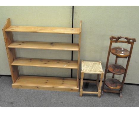 A 20th century mahogany folding cake stand carved with figures under palm trees height 90 cm, a pine wall shelf, 102 x 101 cm