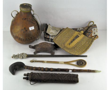 A selection of tribal and oriental collectables, including an Opium pipe with jade mouth piece, carved wooden figure of a tur