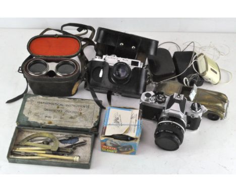 Assorted cameras and photography equipment to include a Zorki 4K, a Nikon, vintage light meters, a pair of binoculars and oth